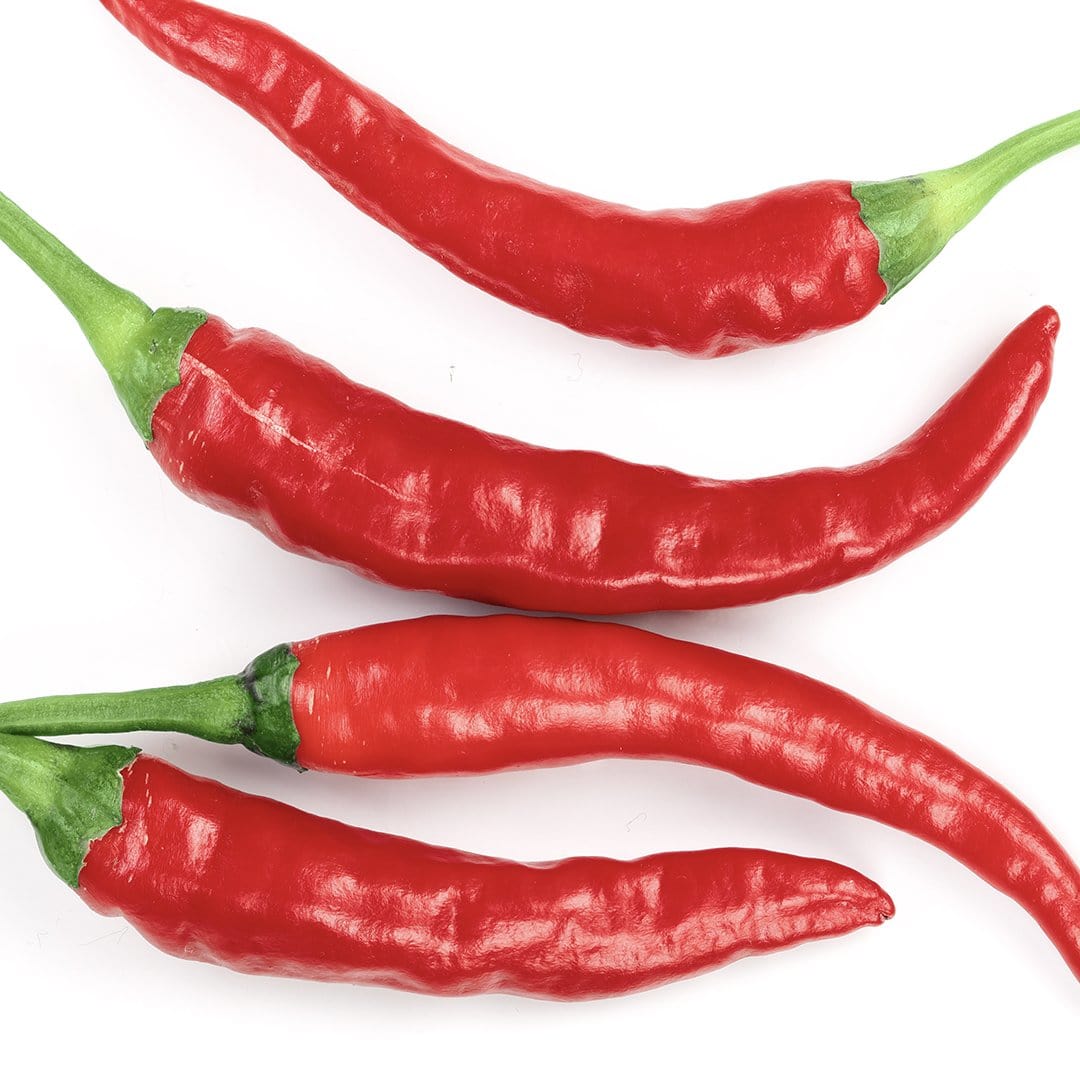 close-up of wrinkled, tapered red cayenne peppers

